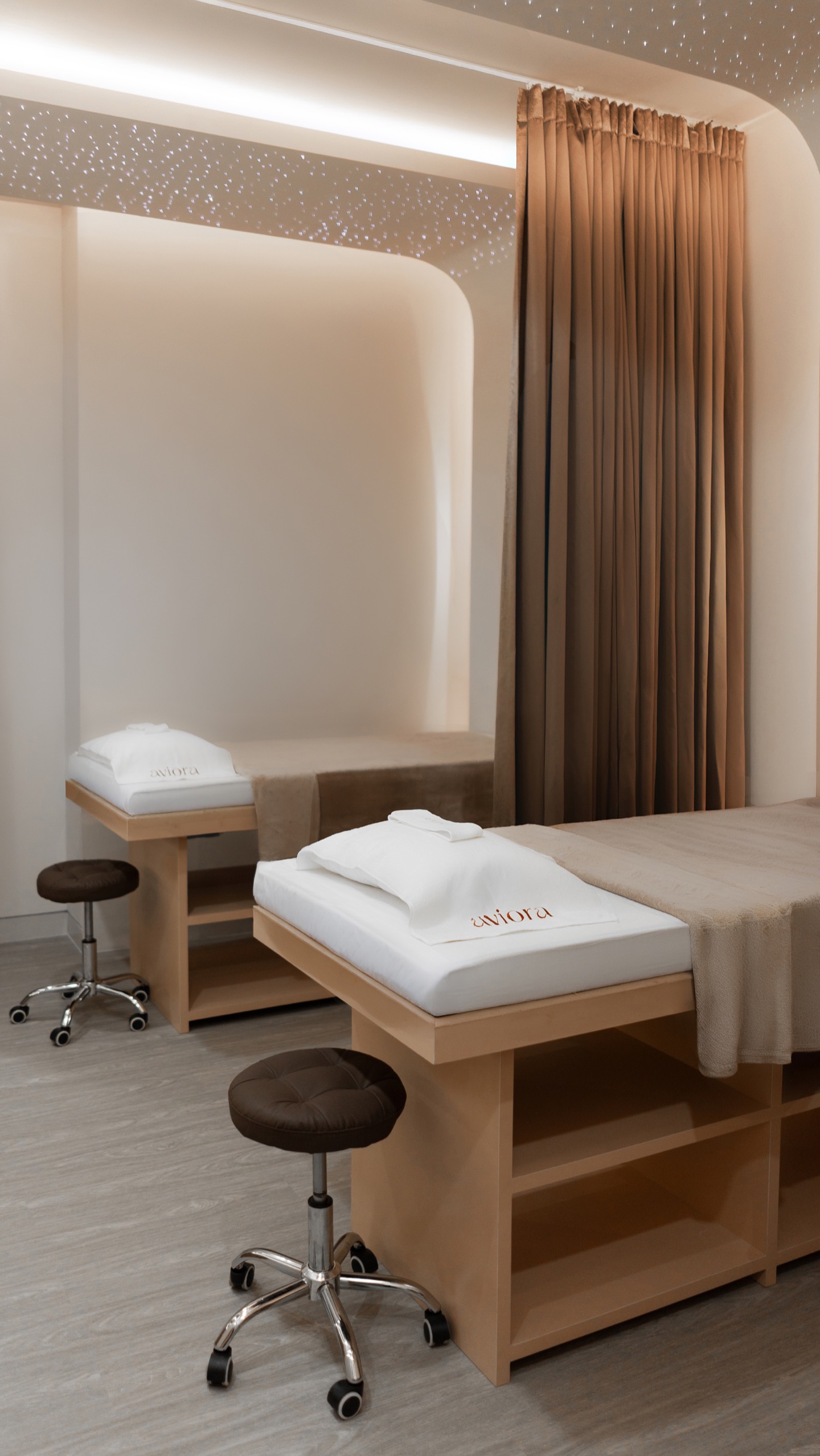 Twin treatment beds with embroidered Aviora cushions