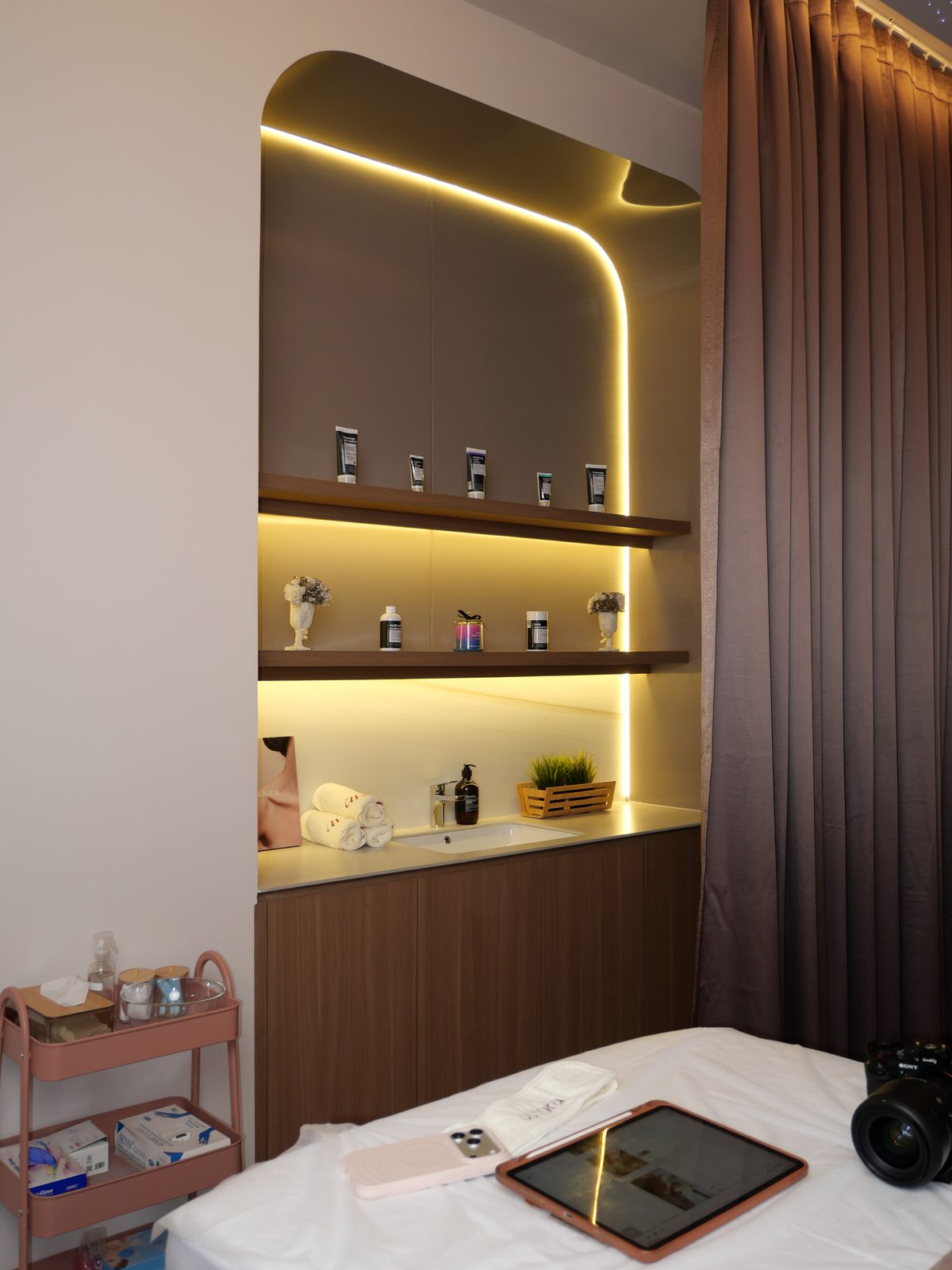 Treatment room with warm backlit shelving